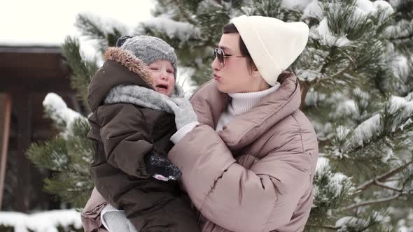 Adorable Mother and Toddler Kids Have Fun Togtether Outside in Sunny Frosrty Day