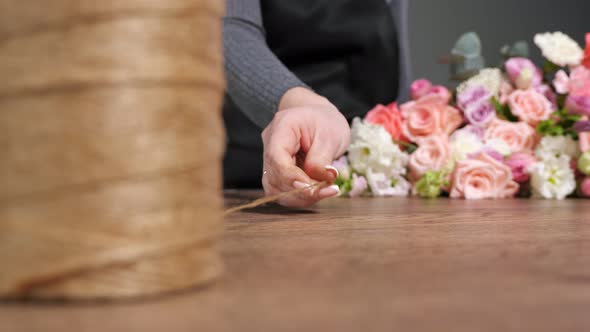 Florist Takes Thin Floral Rope to Fix Flower Composition