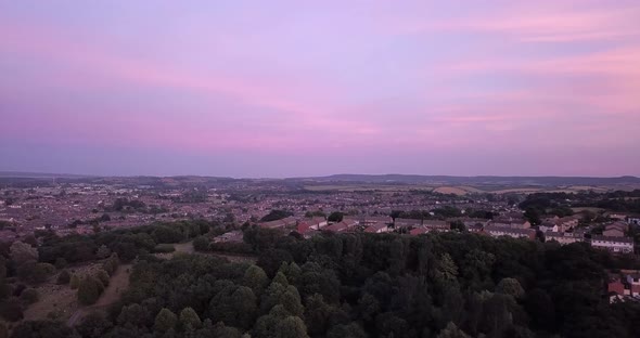 And aerial view of Exeter with blue skys panning from left to right.