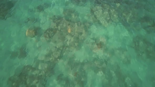 Flying Over Blue Sea Water Surface Crystal Clear Water Beautifully Refracting the Rays on the Blue