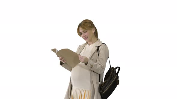 The Pregnant Woman Standing with a Book on White Background.