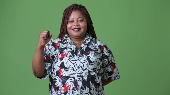 Overweight Beautiful African Woman Against Green Background