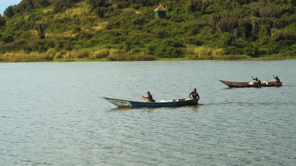 Fishermans paddling to the sea,  Lake Albert Uganda