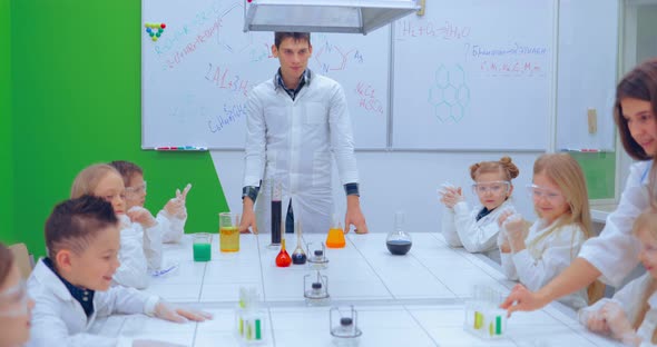 Young Boys and Girls is Making Chemistry Experiments