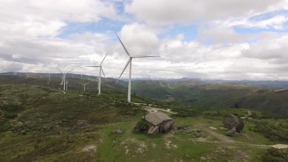Country House in Green Mountains with Wind Turbines