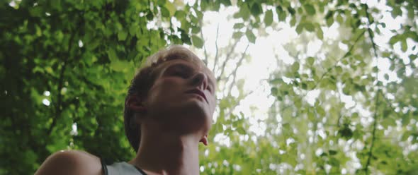 Man stands and breathes in the fresh air