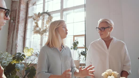 Beautiful Female Florist Teaching Man and Two Women during Masterclass