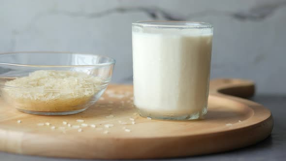 Glass of Milk and Rice on a Table Non Dairy Milk Concept