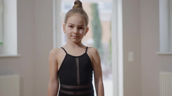 Medium Shot Portrait of Confident Teen Gymnast Looking at Camera Standing Indoors