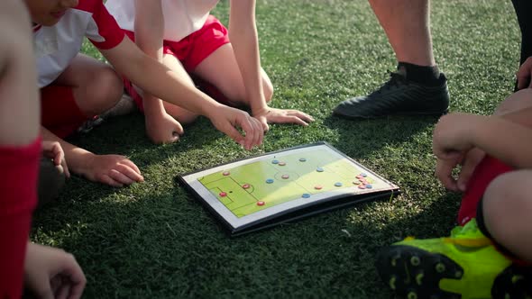 Junior Football Team Coach Explains Game Tactic