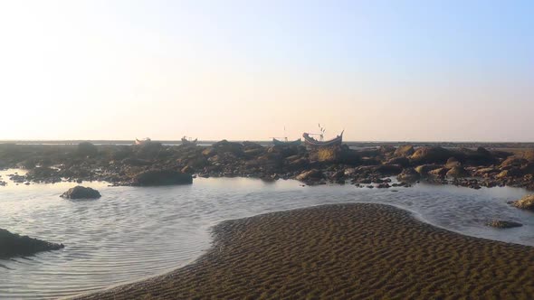 View of the sandy beach and the sea in the Bay of Bengal , traditional wooden boat in Saint Martin'