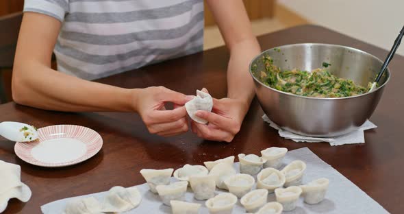 Woman make of chinese meat dumpling at home