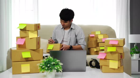 man entrepreneur working with laptop computer prepare parcel boxes for deliver to customer