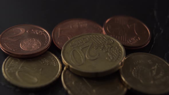 Euro cents coins on old black crumpled wrapping paper 