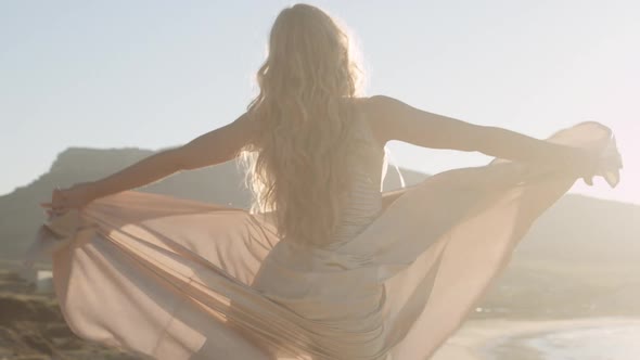 Woman Dancing In Bright Sunlight On Beach