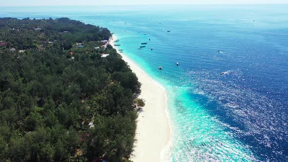 Daytime aerial travel shot of a white paradise beach and aqua turquoise water background in vibrant 