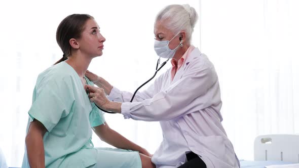 Senior Female doctor checking the symptoms of the woman patient. the concept of health