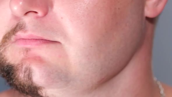 Close Up of a Young Man with a Beard on Half of His Face