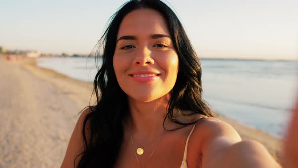 Woman Taking Selfie and Blowing Kiss on Beach