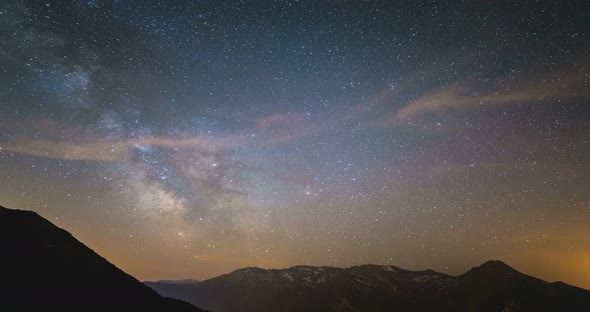 Time Lapse of the Milky way and the stars in summer night sky rotating over the Alps