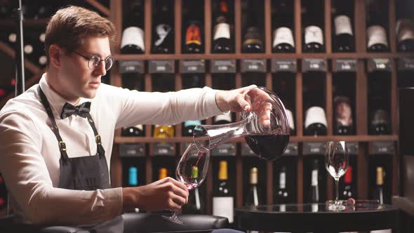 Skilled Sommelier Pouring Wine From Decanter Ino Wine Glass