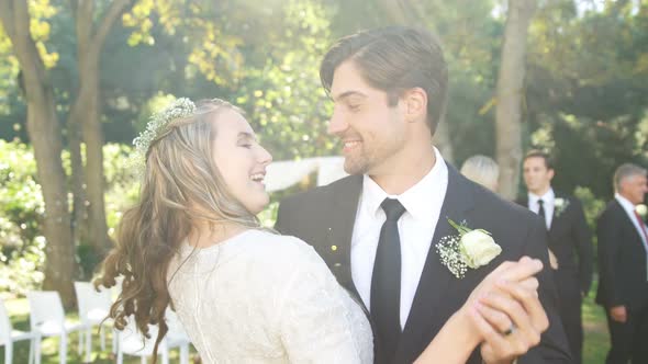 Happy young bride and groom hugging each other while dancing 4K 4k