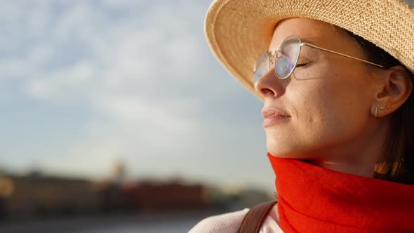 Portrait of attractive woman with red scarf outdoors