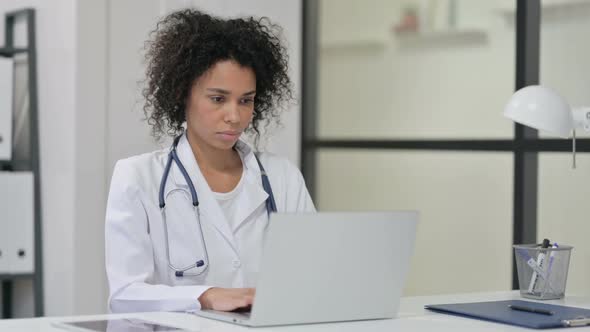 Female African Doctor Working on Laptop
