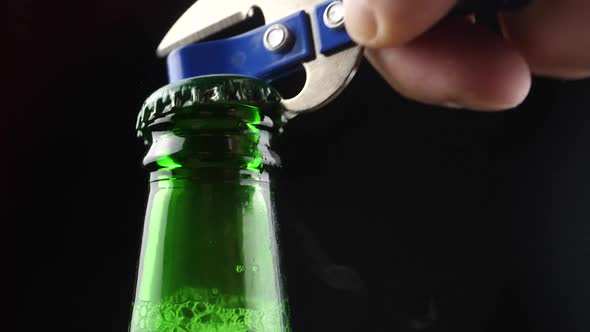 opening a bottle of beer close-up. the lid opens.