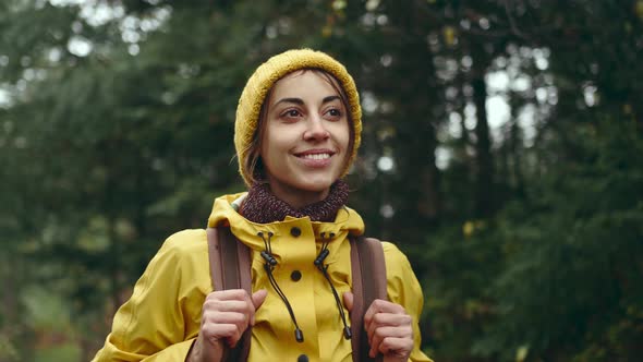 Slow Motion Portrait Young Woman in Red Jacket on Mountain Top at Sunset with Sun Raises and Flares