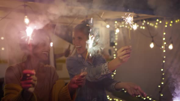 Video of happy friends enjoying while holding sparklers. Shot with RED helium camera in 8K
