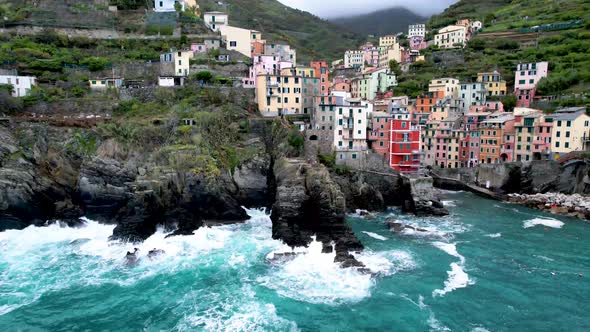 Cinque Terre Drone Video of Riomaggiore Italy rocky coast with crashing waves