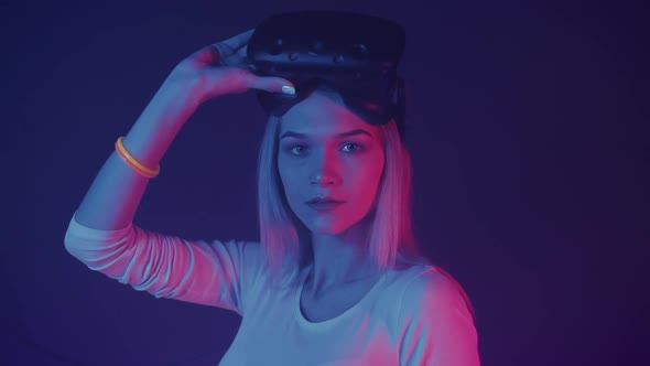 Portrait of Young Attractive Caucasian Blondy Girl Holding Virtual Reality Glasses on Her Head