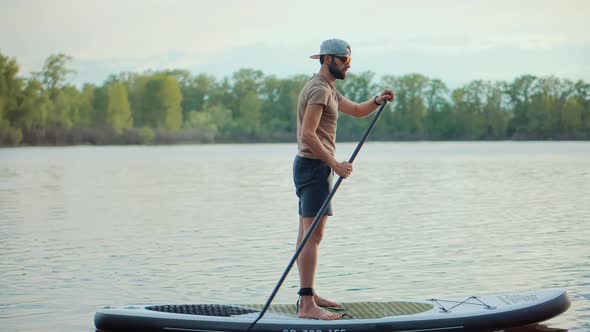 Man Swim Surfing Boat Fitness Workout With Oar Sup Board.Tourist Floating Standup Paddle Board.