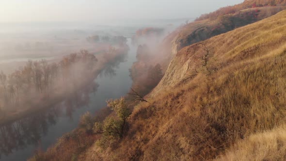 Aerial Drone View of Sunrise Over Misty River