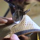 Manufacturing shoes in a shoe factory. Sewing shoes from natural leather (close-up) - VideoHive Item for Sale