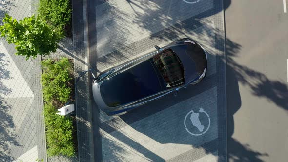 Aerial view of a white electric vehicle driving. 