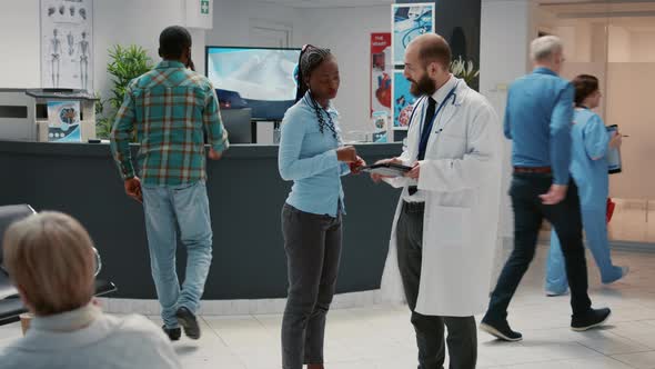 Male Physician Talking to African American Patient About Healthcare