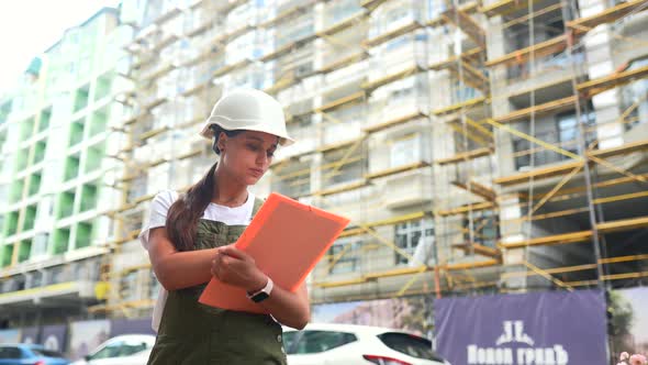 Woman Construction Engineer Wear Safety Hard Hat at Construction Site