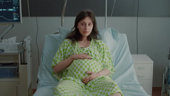 Portrait of Pregnant Woman Laying in Hospital Ward Bed