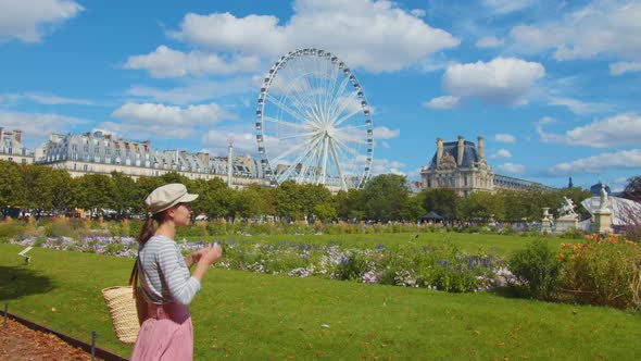 Young tourist taking photo in a park in Paris