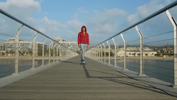 Young attractive athlete running and doing exercises on Bridge in the morning.