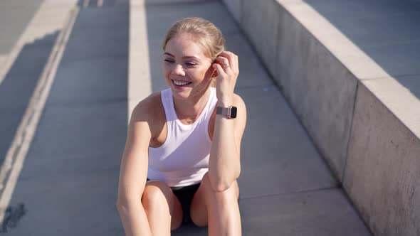 Smiling Woman Sitting on Stairs