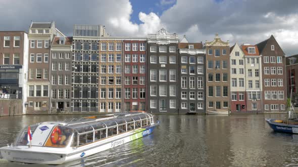 Timelapse of touristic water buses on Amsterdam canal