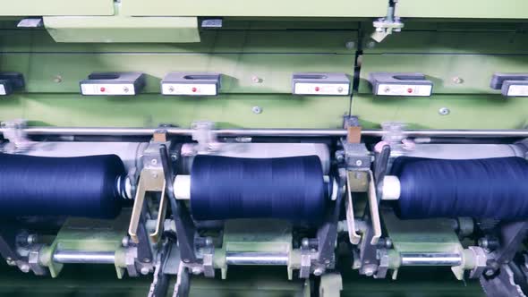 Spools with Coloured Threads Installed Into the Sewing Mechanism