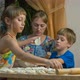 A woman with children are cooking meat pies - VideoHive Item for Sale