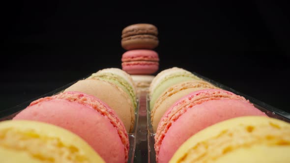 Colored Macaroons Confectionery Marshmallows on a Black Reflective Background in Perspective