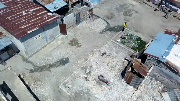 Drone footage flying low over a slum in Port au Prince