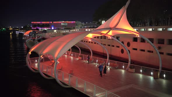 Couple walking on the Tampa Riverwalk at night