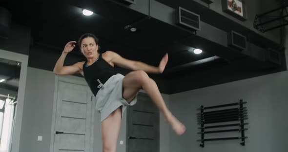 Woman Kickboxer Does Training Squats and Highkicks in Slow Motion Female Athlete Does Physical